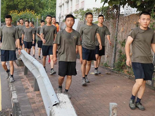 Personnel from the Chinese People's Liberation Army barracks in Hong Kong emerged to help clean up the city after more protests. Picture: AFP