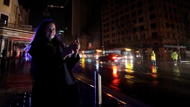 Brisbane visitor Dana Holden at the corner of King William St and Rundle Mall during the unprecedented statewide blackout in 2016. Picture: Kelly Barnes/The Australian