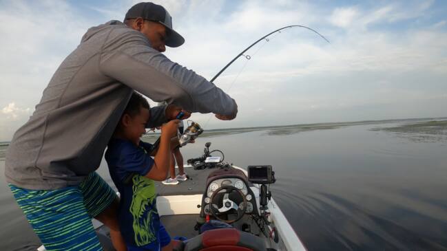 Viral video captures 6-year-old catching 8lb fish while his father