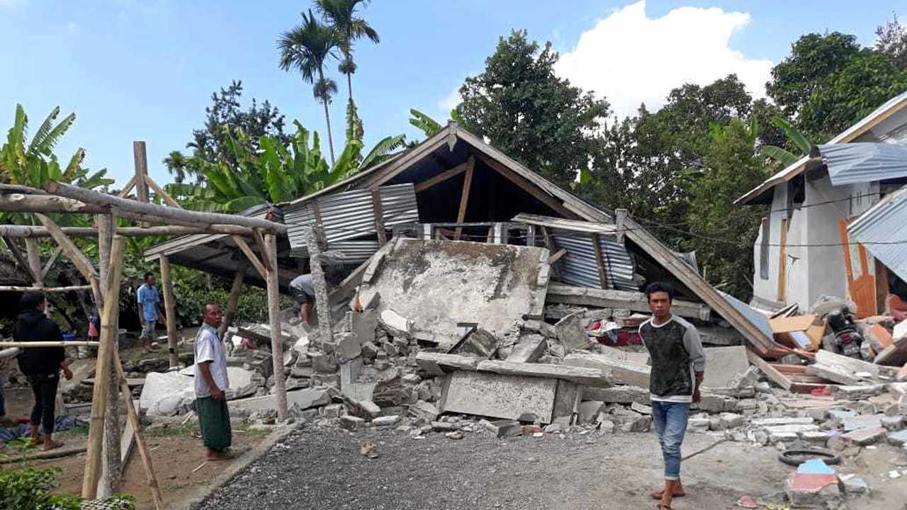 VILLAGERS walk near destroyed homes in an area affected by the early morning earthquake at Sajang village, Sembalun, East Lombok, Indonesia, on July 29, 2018. The death toll has reached 380 and is still rising. Picture: Rosidin