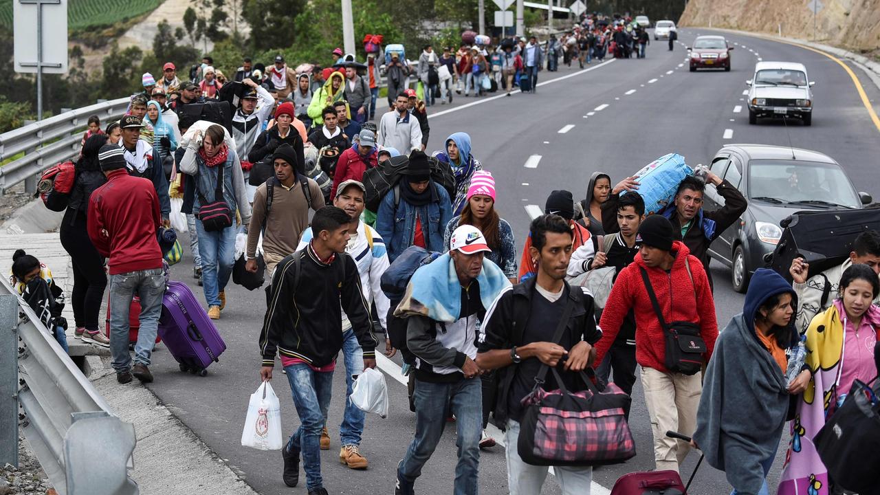 Venezuelan migrants head to Peru along the Panamerican highway in Tulcan, Ecuador. Picture: Luis Robayo/AFP