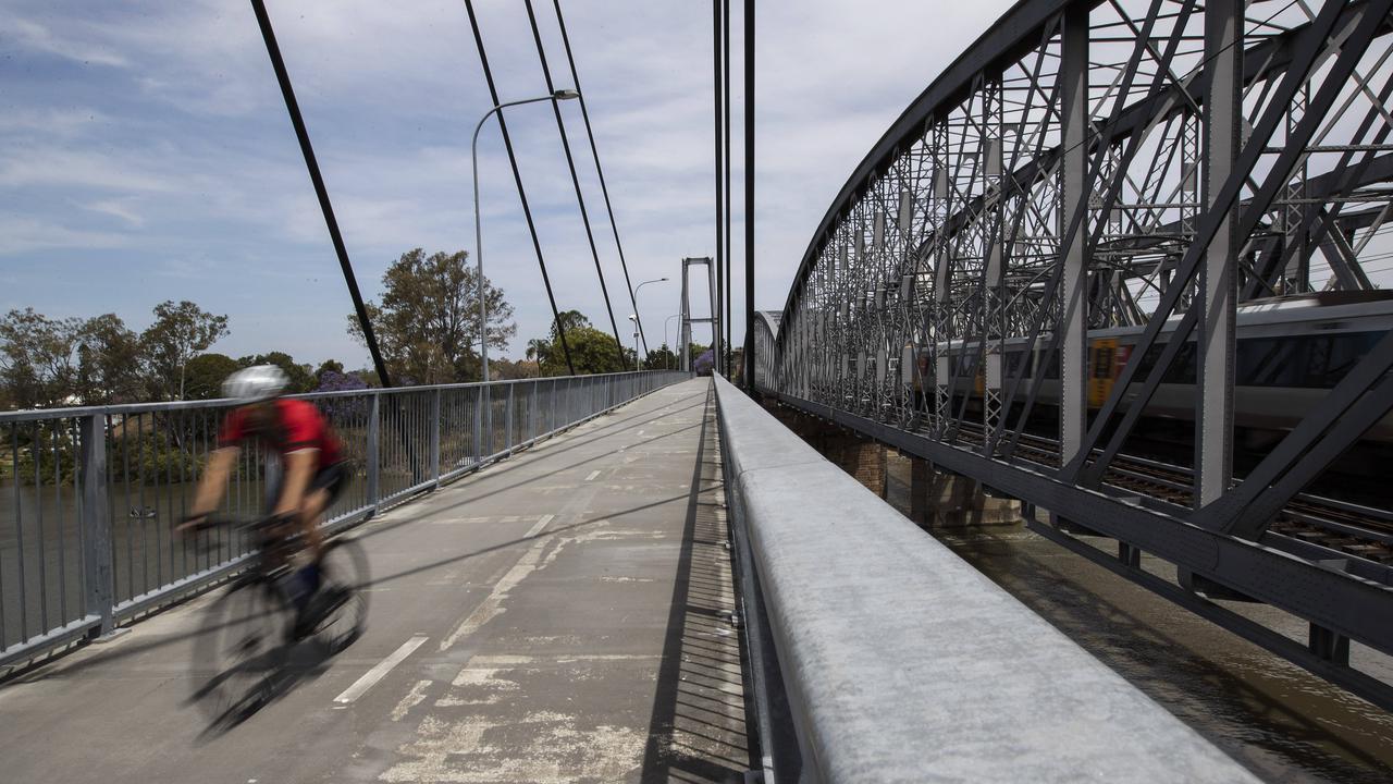 Cyclist seen on a pedestrian bridge in Indooroopilly. Picture: News Corp/Attila Csaszar