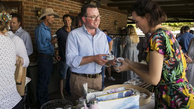 Agriculture Minister Adam Marshall makes a purchase from Laura Noonan who owns The Beauty Room Warren during the State Cabinet visit to Nevertire. Picture: Dylan Robinson