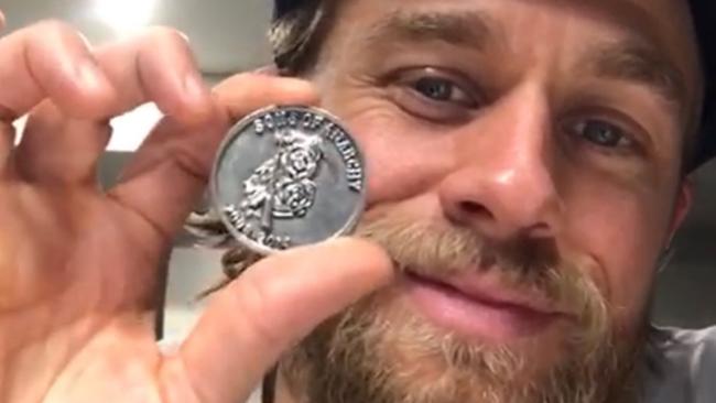 Charlie Hunnam with the “challenge coin”