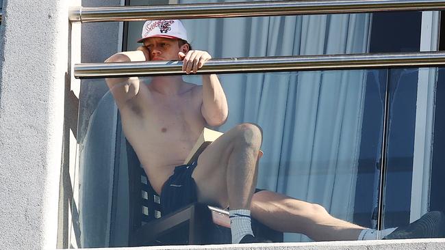 Callum Mills watching his teammates train from his balcony today. Picture: Michael Klein