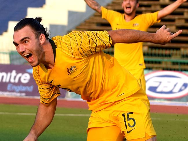 Australia's Nicholas D'Agostino (L) celebrates after scoring a goal during the Tokyo 2020 Olympic Games men's Asian qualifier football match between South Korea and Australia at the National Olympic Stadium in Phnom Penh on March 26, 2019. (Photo by TANG CHHIN Sothy / AFP)