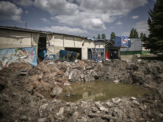 A crater is pictured in front of a destroyed supermarket after a strike in the city of Soledar at the eastern Ukranian region of Donbas. Picture: AFP