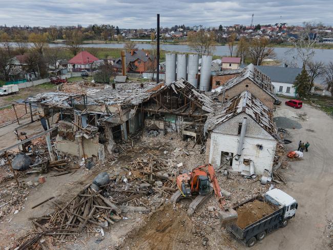 An excavator drops the debris in a truck outside the bread factory that was bombed during the Russian invasion west of Kyiv in Makariv, Ukraine. At least 13 people were reported dead after the bombing of the factory. Picture: Getty Images