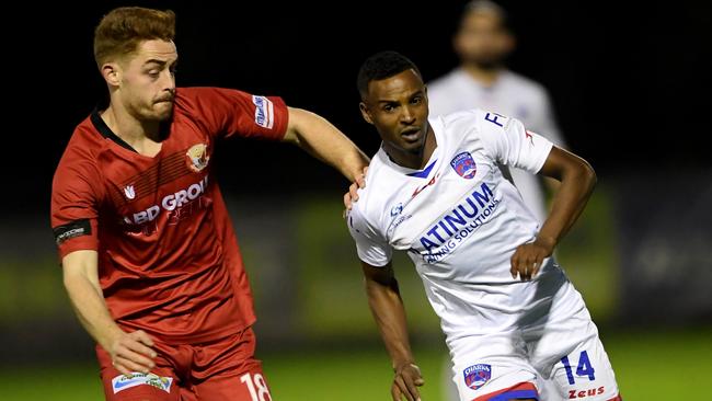 Thomas Harris and Kamal Ibrahim battle for the ball. Picture: Andy Brownbill