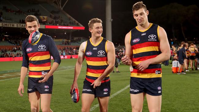 Paul Seedsman, Matt Crouch and Josh Jenkins are all smiles after the win against North Melbourne on Sunday. Picture: James Elsby/AFL Media/Getty Images