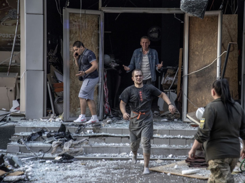 Wounded civilians walk out in shock from the Ria restaurant. (Photo by Narciso Contreras/Anadolu Agency via Getty Images)