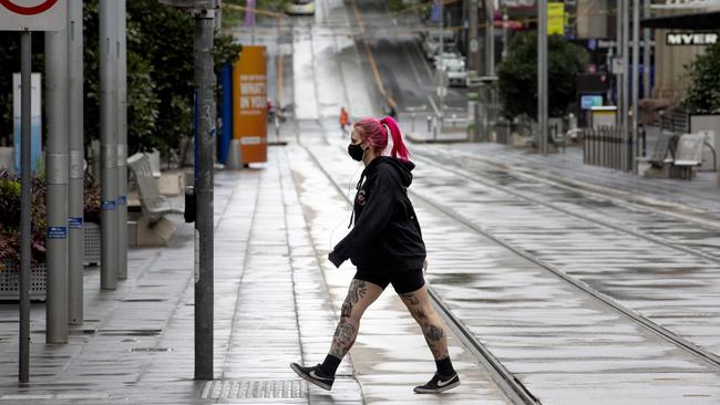 A woman crosses a deserted Bourke St. Picture: NCA NewsWire / David Geraghty