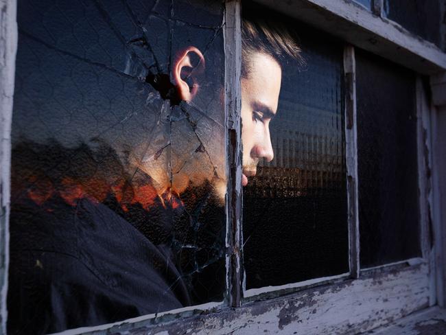 27 September 2024; Photo comp of a photo of a window of the dilapidated former Rozelle Hospital in Sydney, previously called Callan Park, was one of the largest mental asylums in the nation before it was shut and an image of a man's forlorn face looking outside the window; Sources: Max Mason-Huber and iStock. Photo comp by Emilia Tortorella. Ratio 16:9.