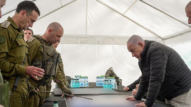 Benjamin Netanyahu, right, and Israeli army Chief-of-Staff Herzi Halevi, left, during a briefing in the Netzarim Corridor, Israel's main military supply route. Picture: AFP