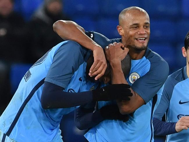Yaya Toure (L) celebrates with Vincent Kompany (2L).
