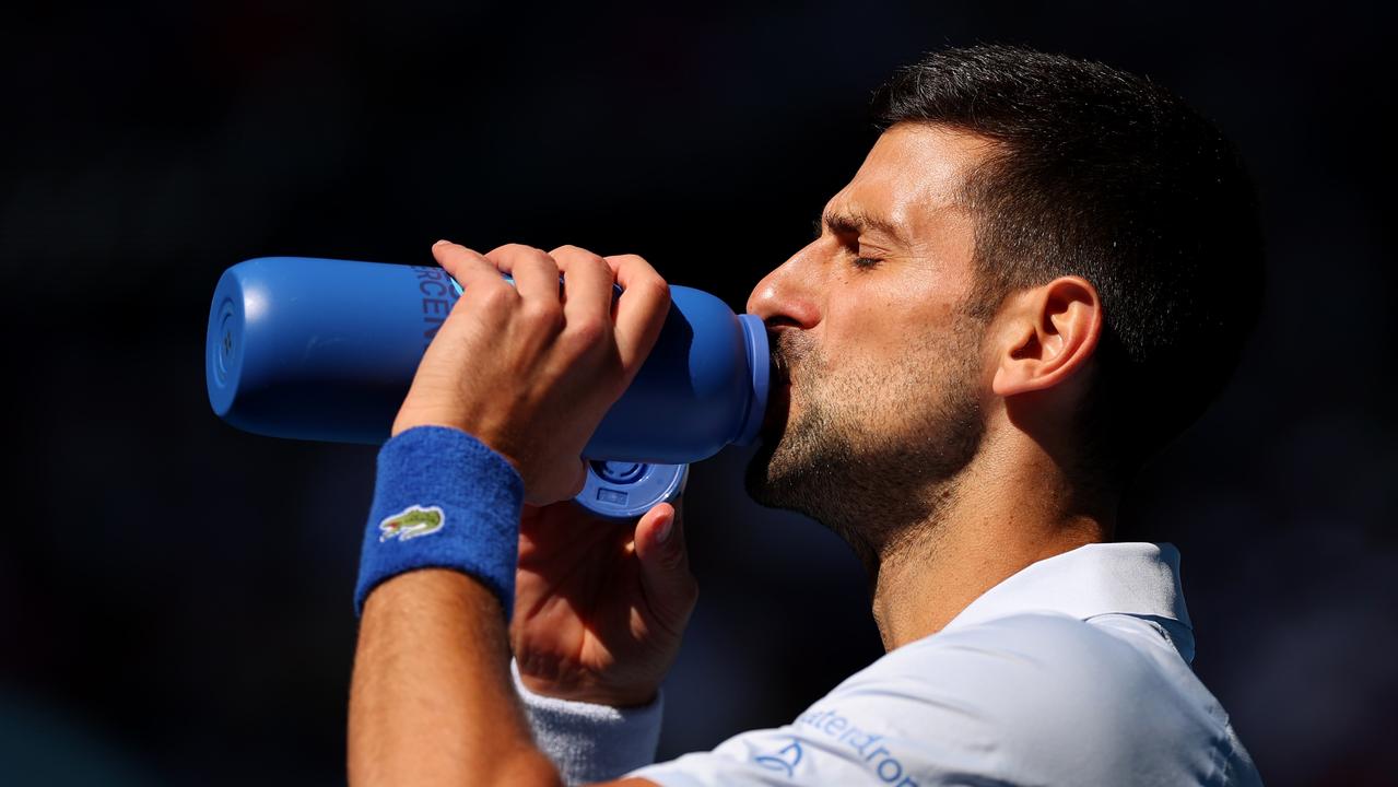 Novak Djokovic battles the heat. (Photo by Cameron Spencer/Getty Images)