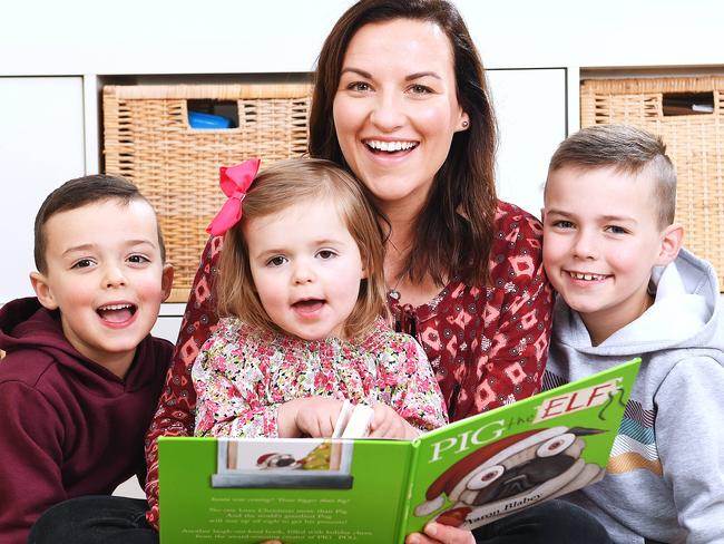 Nicole Tropeano-Atyeo reads with her children Ollie 8,Archie 5 and Frankie 3 at their Flinders park Home Wednesday June 19,2019.(Image AAP/Mark Brake)