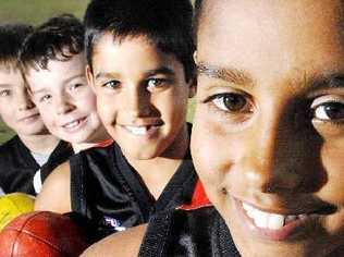 Some of the Ballina Bomber’s youngest AFL players (from front) Jeremy Jago, 10, Patrick Jago, 9, Will Bainbridge, 8, and Ned Bainbridge, 6, are happy they’ll soon be able to play under proper lighting at Fripp Oval in Ballina. Picture: Jay Cronan