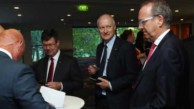 Richard Goyder, second from right, is asked for his ID last night. Picture: Hollie Adams.