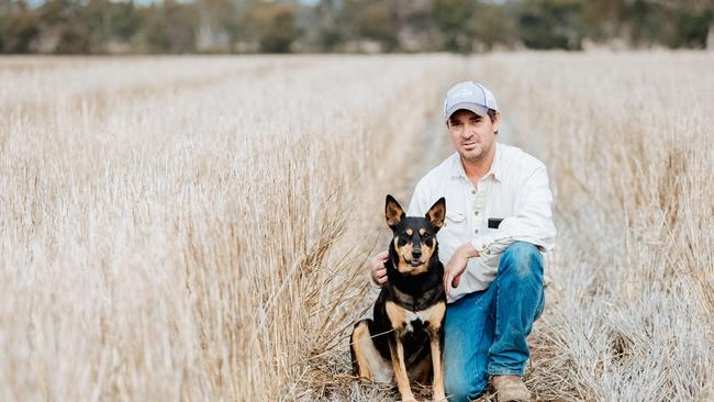 Tom Dunstan from Telangatuk East with his dog Lucy, in a paddock recently sown to faba beans, while retaining stubble for moisture residue. Picture: Chloe Smith