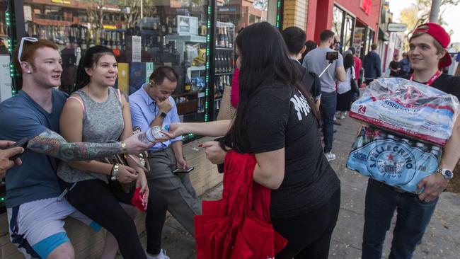 Employees give water to people waiting in line to get into MedMen, one of two Los Angeles pot shops that began selling recreational marijuana under new Californian law. Picture: David McNew/Getty/AFP