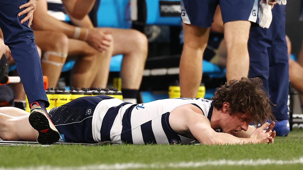 Max Holmes of the Cats lies on the ground after injuring his hamstring in the preliminary final.