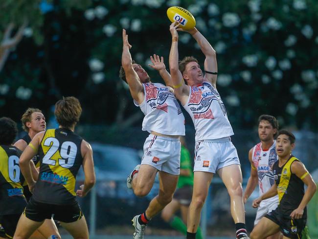 Districts’ Jesse Clark jumping for the ball against Nightcliff. Picture GLENN CAMPBELL