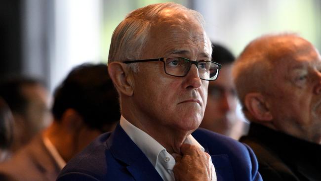 Former prime minister Malcolm Turnbull listens to New South Wales Energy Minister Don Harwin speak prior to delivering an address at the NSW Smart Energy Summit in Sydney, Tuesday, December 4, 2018. (AAP Image/Dan Himbrechts) NO ARCHIVING