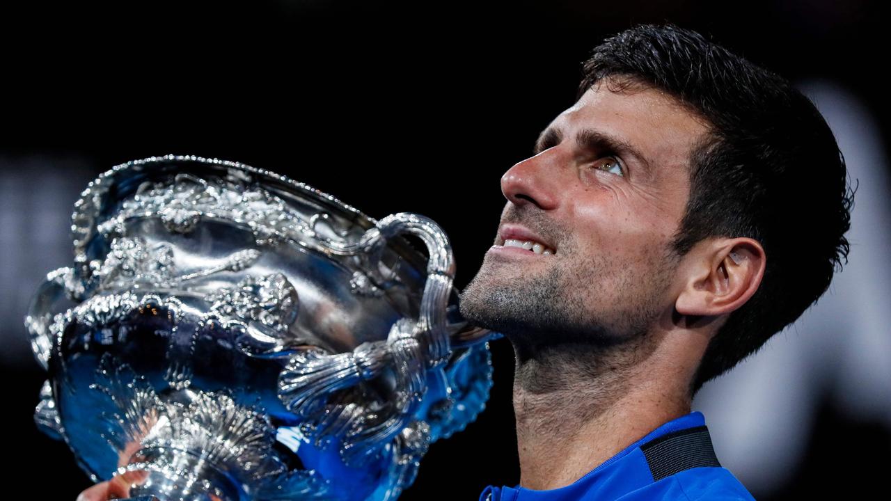 Serbia's Novak Djokovic celebrates with the championship trophy.