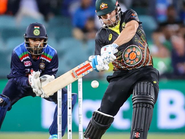 Australia's captain Aaron Finch hits a boundary during the T20 cricket match between India and Australia at Manuka Oval in Canberra on December 4, 2020. (Photo by DAVID GRAY / AFP) / -- IMAGE RESTRICTED TO EDITORIAL USE - STRICTLY NO COMMERCIAL USE --