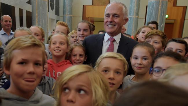 Australian Prime Minister Malcolm Turnbull is surrounded by year 5 students from Malvern Primary in Melbourne after speaking to members of the Australian Publc Service during an Institute of Public Administration Australia event at Parliament House in Canberra, Wednesday, April 20, 2016. (AAP Image/Lukas Coch) NO ARCHIVING