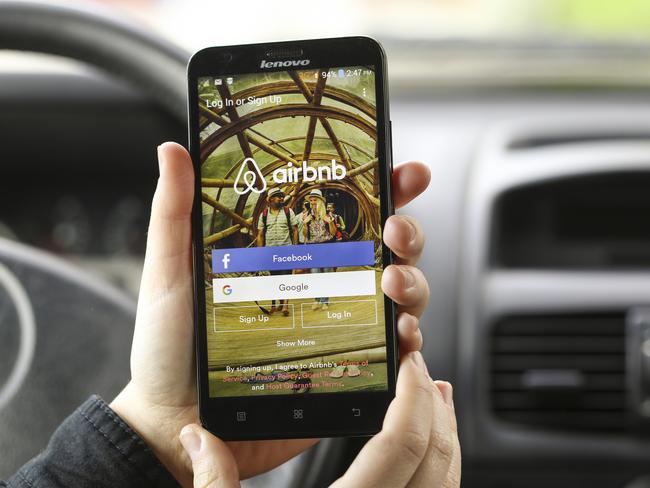 Novi Sad, Serbia - March 24, 2016: Close-up of an unrecognizable woman using the Airbnb App on her Lenovo A916 Android smartphone in a car. Login screen with Facebook and Google sign up options. Airbnb is a service for people to list, find, and rent lodging. It currently has over 1,500,000 listings in 34,000 cities and 190 countries.