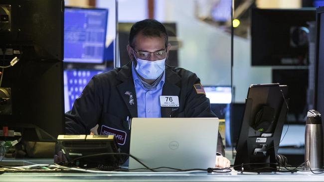 Trader Aman Patel wears a mask as he works on the partially reopened trading floor at the New York Stock Exchange. Picture: AP