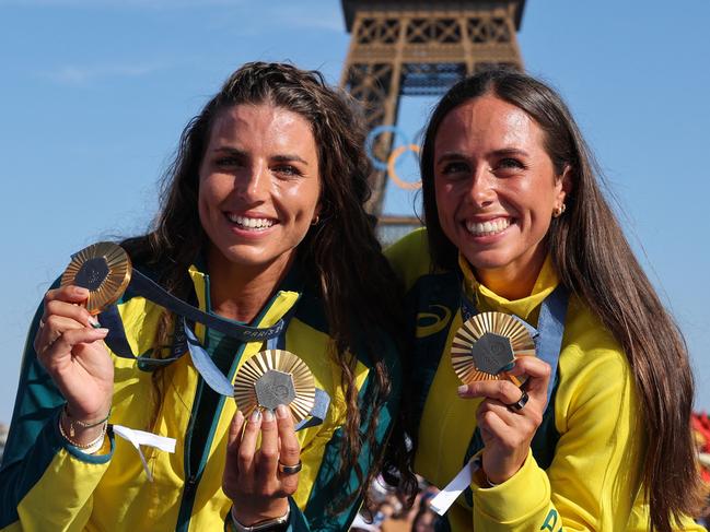 Australia's gold medallists and Jessica and Noemie Fox pose with their medals on stage at the Champions Park at Trocadero during the Paris 2024 Olympic Games in Paris on August 6, 2024, with the Eiffel Tower visible in the background. (Photo by Jack GUEZ / AFP)