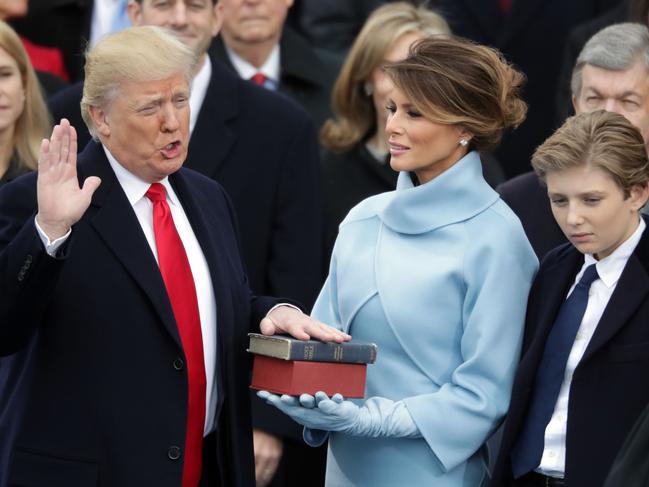 President Donald Trump takes the oath of office as his wife Melania Trump holds the bible and his son Barron Trump looks on, on the West Front of the U.S. Capitol on January 20, 2017 in Washington, DC. Picture: AFP