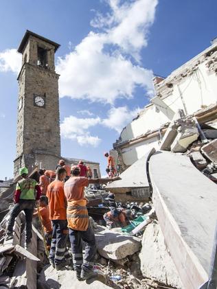 Rescuers search through debris near the centre of the town. Picture: Massimo Percossi/ANSA via AP