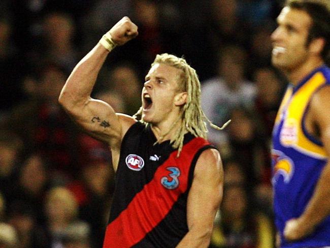 Courtney Johns celebrates a goal next to Chris Judd.