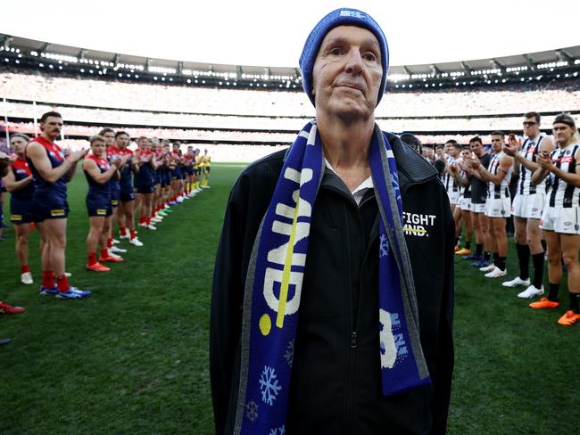 MELBOURNE - June 12 : AFL.   Neale Daniher walks through a guard of honour made up by players of both teams before the round 13  AFL match between Melbourne and Collingwood at the MCG on June 12 , 2023, in Melbourne, Australia. Photo by Michael Klein.