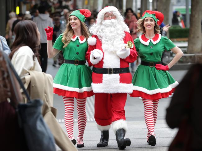 Christmas Precinct Grants Program in Melbourne CBD. Santa with elves Ellie and Ellen walk among the shoppers in the the Bourke Street Mall.                       Picture: David Caird