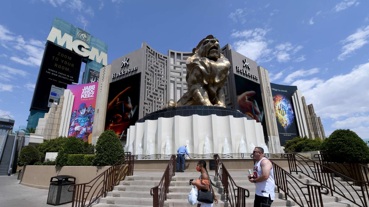 Visitors walk in front of the deserted MGM Grand Hotel &amp; Casino on the Las Vegas Strip. At the time MGM Resorts International laid 18,000 employees as the resort industry struggles to recover from the pandemic. Picture: Ethan Miller/Getty Images