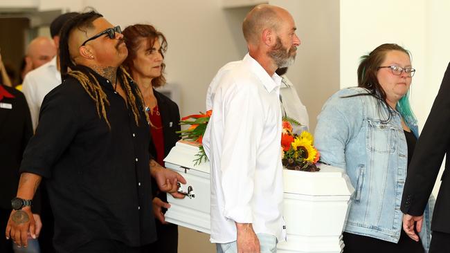 The kids’ mother Jasmine Beck, right, carries one of the coffins. Picture: Alison Wynd