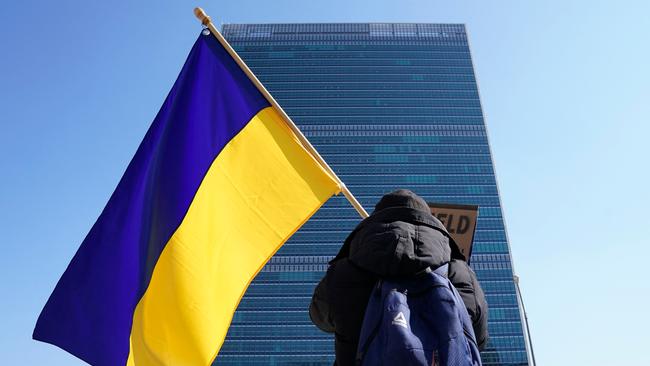 A protester with a Ukrainian flag demonstrates outside the United Nations headquarters in New York. Picture: Timothy A. Clary/AFP