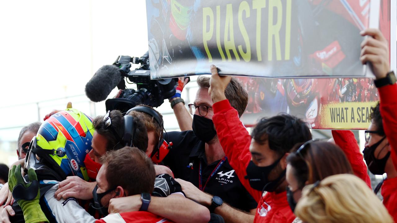 Piastri is mobbed by his Prema team. (Photo by Mark Thompson/Getty Images)