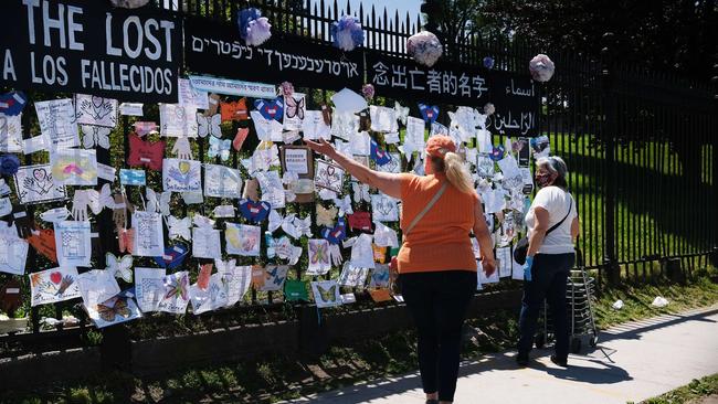 People walk by a memorial for those who have died from the coronavirus outside Green-Wood Cemetery in May in the Brooklyn borough of New York City. Picture: Spencer Platt/Getty Images/AFP