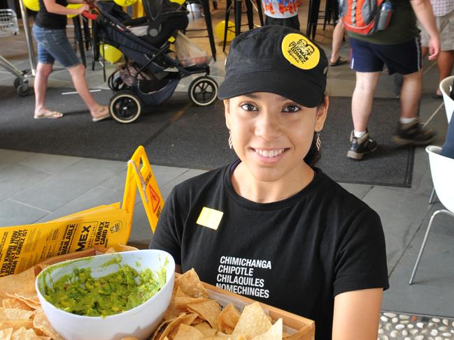 Itzel Castillo provides a snack for people queueing at the North Lakes Guzman Y Gomez free Burrito give-away.