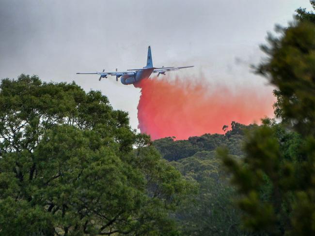 An aircraft dumps fire retardant at the Buninyong blaze. Picture: Ian Wilson