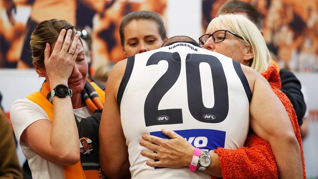 Tomlinson hugs his family and friends after last year’s Grand Final loss. Picture: Getty