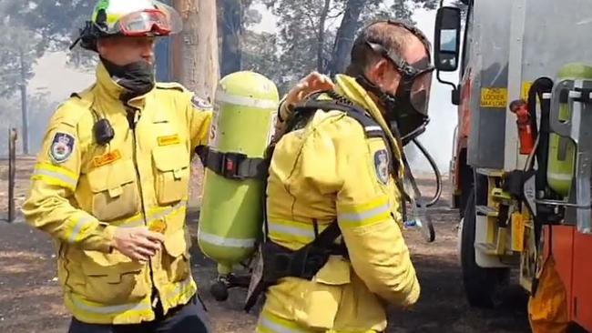 Tony Abbott gets kitted up with breathing apparatus before running to help put out a house fire at Bendalong. Picture: Ingleside RFS