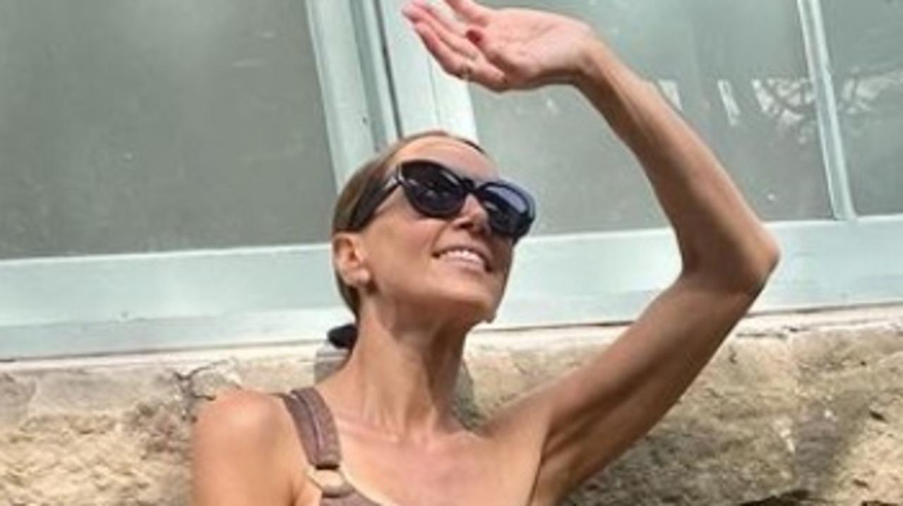 Kyly Clarke poses up a storm in a stylish off-the-shoulder Jets swimsuit