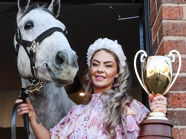 Trainer Gemma Rielly with former race horse Archie (Clark of the Course horse) having a beer with the Caulfield Cup in The Emerald Hotel Sports Bar South Melbourne.                    Picture: David Caird